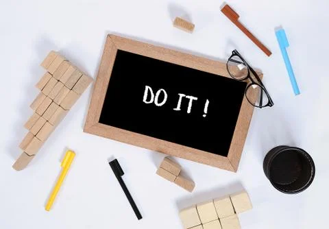 Do it text on blackboard with office accessories. Business motivation, inspir Stock Photos
