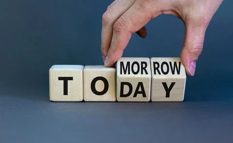 Do it today not tomorrow. Businessman turns wooden cubes and changes the word Stock Photos