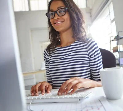 Do it today or regret it tomorrow. a young female designer working on her Stock Photos