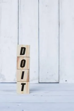 Do it word or concept on wooden blocks, white wood background Stock Photos