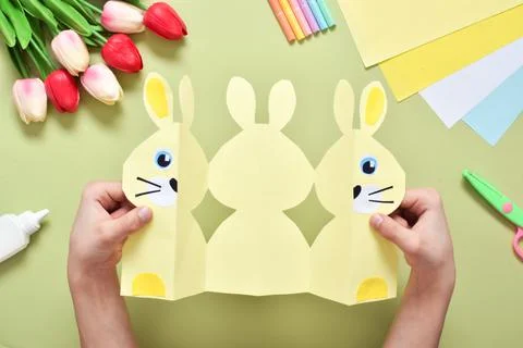 Do it yourself. A children's postcard made of paper with a rabbit. Step-by-st Stock Photos
