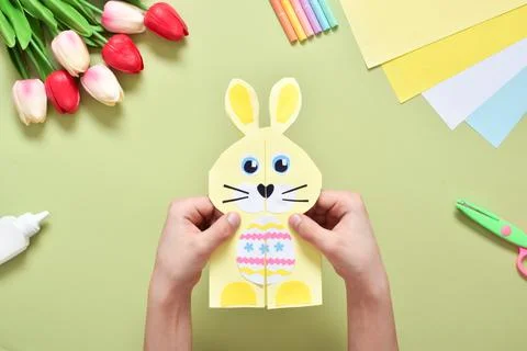 Do it yourself. A children's postcard made of paper with a rabbit. Step-by-st Stock Photos