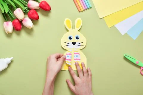 Do it yourself. A children's postcard made of paper with a rabbit. Step-by-st Stock Photos