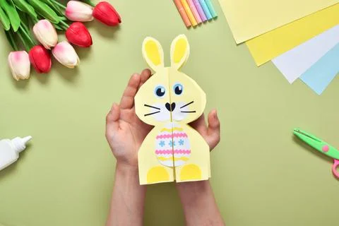 Do it yourself. A children's postcard made of paper with a rabbit. Step-by-st Stock Photos