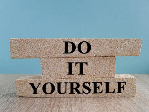 Do it yourself symbol. Concept word Do it yourself on brick blocks. Stock Photos