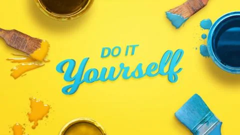 Do it yourself text surrounded with color brushes and boxes and a few drops o Stock Photos