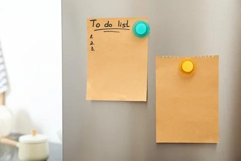 To do list and empty sheet of paper with magnets on refrigerator door in kitc Stock Photos