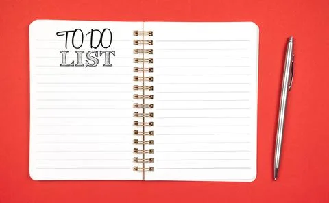 To do list concept. Planning for new year. Red background, silver pen, copy s Stock Photos