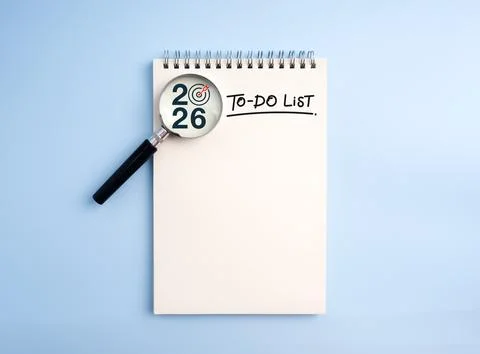 To-do list notebook with magnifying glass focusing on 2026 and target icon .. Stock Photos