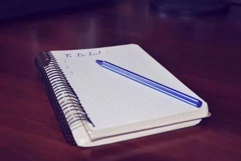 To do a list notebook on the wood table Stock Photos