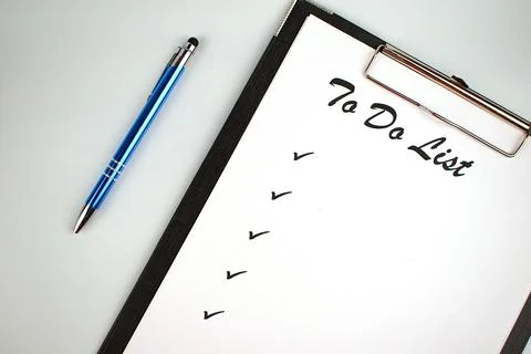 To do list. Notepad with a white sheet of paper, next to the pen on an white  Stock Photos