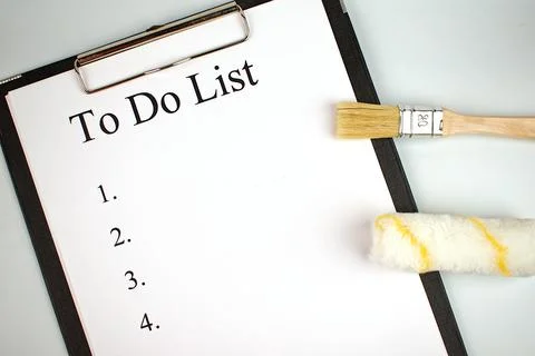 To do list. Notepad with a white sheet of paper, next to brush and roller on  Stock Photos
