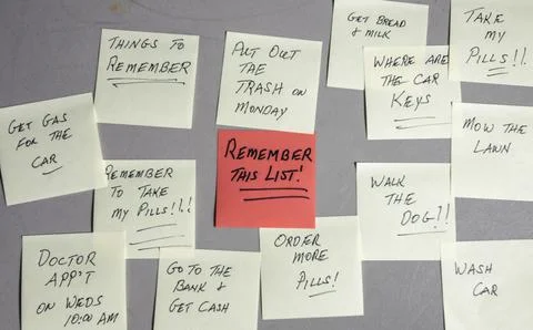 To-do List With Reminders Written on Sticky Notes Stuck on a Wall in a Room Stock Photos