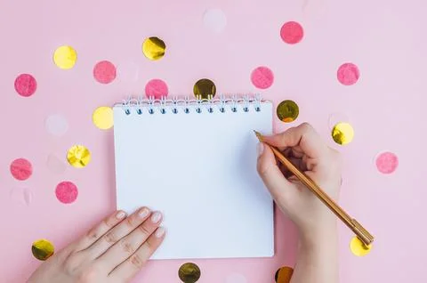 To do list in spiral notepad on pink festive background. Flat lay, top view. Stock Photos