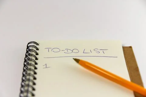 To do list in spiral notepad. White background, flat lay style. Stock Photos