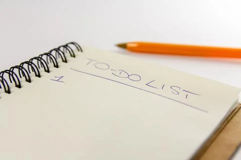 To do list in spiral notepad. White background, flat lay style. Stock Photos