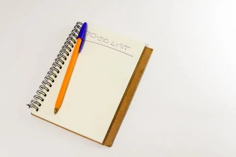 To do list in spiral notepad. White background, flat lay style. Stock Photos