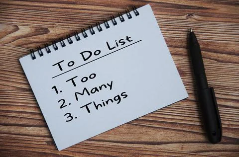 To Do List text on notepad with pen on wooden table. Conceptual Stock Photos