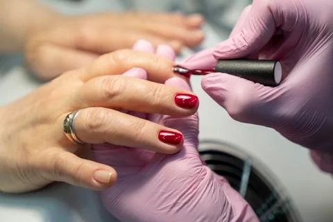 Do manicure, nail red lacquer close-up Stock Photos