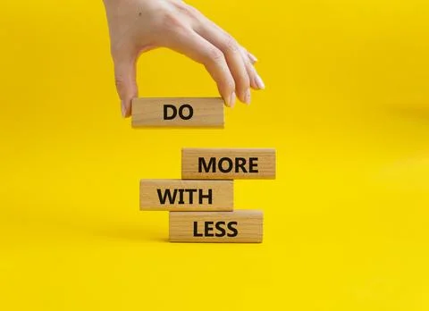 Do more with less symbol. Concept words Do more with less on wooden blocks... Stock Photos