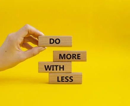 Do more with less symbol. Concept words Do more with less on wooden blocks... Stock Photos
