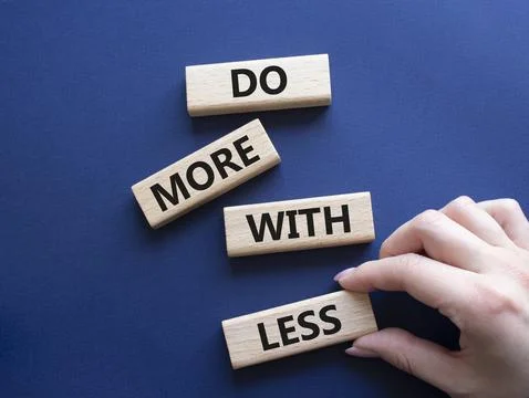 Do more with less symbol. Concept words Do more with less on wooden blocks... Stock Photos