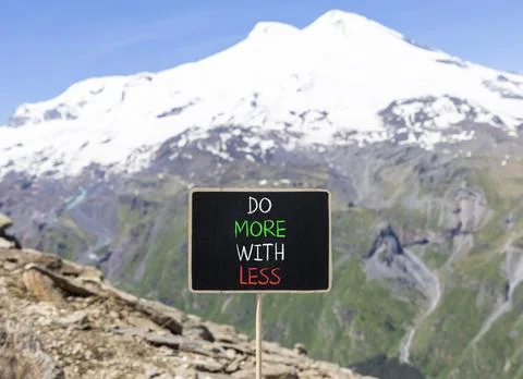 Do more with less symbol. Concept word Do more with less on beautiful black.. Stock Photos