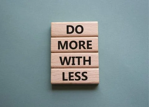 Do more with less symbol. Concept words Do more with less on wooden blocks... Stock Photos