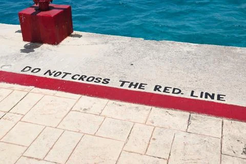 Do not cross red line sign on a pier Stock Photos