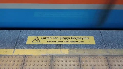 Do Not Cross Yellow Line Sign at Subway Platform as Fast Train Passes Stock Footage 340213204