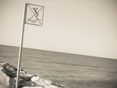 Do not dive advice  long an Italian beach Stock Photos