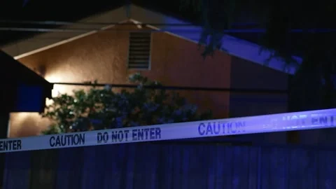 Do not enter caution tape near house at night police lights Stock Footage 346063484