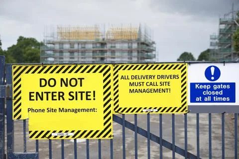 Do not enter construction in progress sign on fence Stock Photos