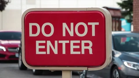 Do not enter rectangle red and white sign with cars vehicles lined up behind Stock Footage 249760204