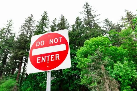 Do Not Enter Sign Restriction Amidst Forest Area Stock Photos