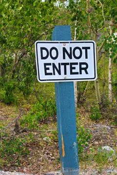 A do not enter sign with trees in the background Stock Photos
