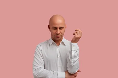 Do not interfere, I need to think. Portrait of serious bald man in white shir Stock Photos