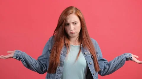 Do not know, sorry. Portrait of clueless young woman, feeling confused about Stock Footage 140913650