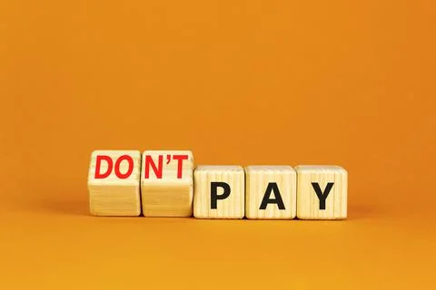 Do not pay symbol. Concept words do not pay on cubes. Beautiful orange table  Stock Photos