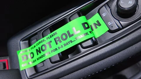 Do not roll down or wash windows, sticker on the vehicle door buttons, remi.. Stock Footage 315355779
