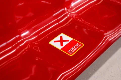 Do not sit here sticker red X sign on seat in train,Social distancing for cov Stock Photos