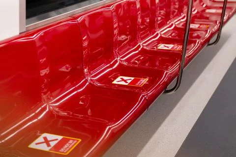 Do not sit here sticker red X sign on seat in train,Social distancing for cov Stock Photos