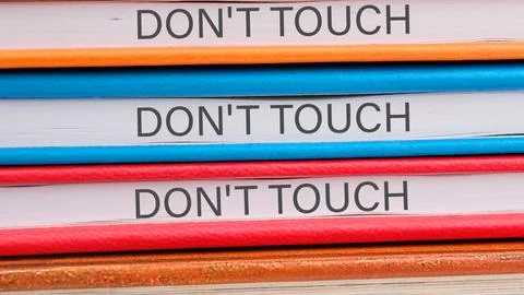 Do not touch me close-up on the ends of the notebooks Stock Photos