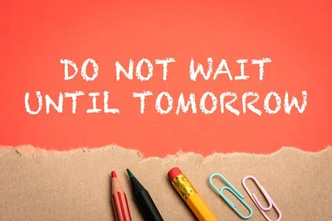 Do Not Wait Until Tomorrow. Office supplies and torn cardboard on a red Stock Photos