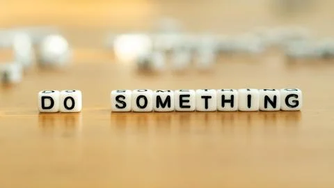 Do something slogan in white block letter beads Stock Photos
