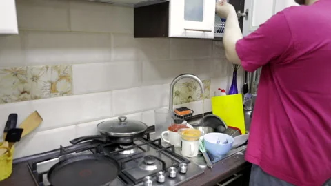 Do washing dishes at the kitchen Stock Footage 152978026