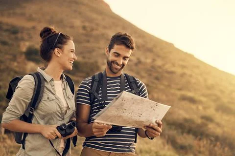 Do you even understand maps, babe. Shot of a couple looking at a map while ou Fotos Stock