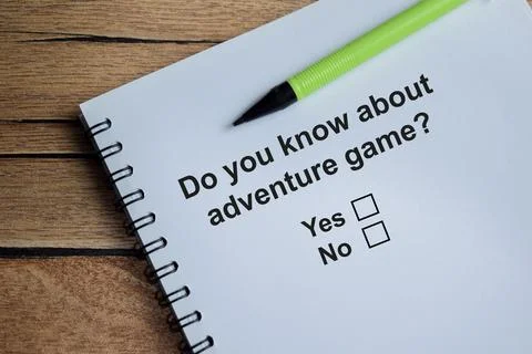 Do you know about adventure game write on book isolated on Wooden Table. Stock Photos