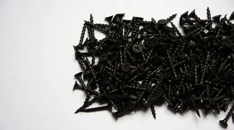 Do You Stand Out In A Crowd? Macro of one brass screw in a pile of black screws Stock Footage 42533288