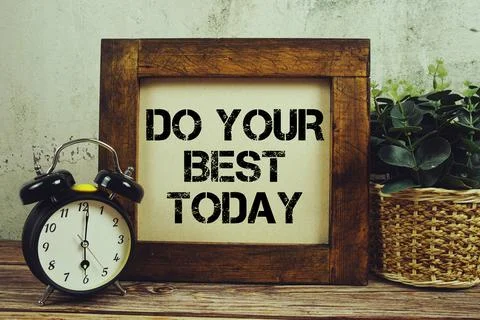 Do Your Best Today text with alarm clock on wooden background Stock Photos